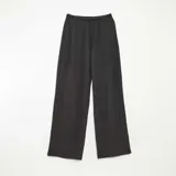 Pantalón ancho negro de punto crepé con cintura elástica y cordón ajustable.