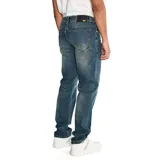 Pantalón de jean color verde militar, de corte slim, con cinco bolsillos y logo CAT en la parte trasera.