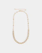 Collar corto dorado con cadena de eslabones y dije de strass con forma de corazón.