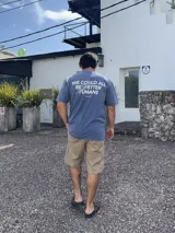 Remera celeste con acid wash y estampa en la espalda con la frase "We could all be better humans. Prioritize yourself".