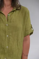Camisa verde oliva de lino italiano, con botones al frente y mangas cortas con botón para ajustar el largo.