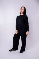 Pantalón negro de tejido de punto acanalado, corte palazzo y cintura alta con lazo ajustable.