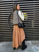 Falda midi color borgoña, con corte irregular y ruedo asimétrico.