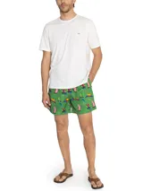 Short de baño verde con estampado de loros de colores, cintura elástica y cordón ajustable.