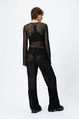 Pantalón de encaje negro con transparencias y cintura con elástico.