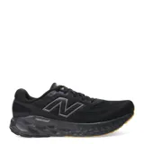 Championes de running New Balance color negro, con detalles en gris y suela color caramelo.
