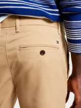 Pantalón chino Tommy Hilfiger de la colección 1985, color beige, corte slim y pierna recta. Confeccionado en algodón pima elástico.