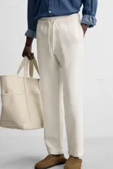 Pantalón largo verde oscuro de algodón con textura, corte recto y cintura elástica ajustable con cordón.