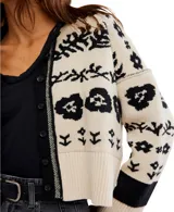 Cárdigan de tejido de punto grueso, color marrón oscuro con estampado jacquard en blanco de motivos florales y náuticos. Presenta cuello camisero y cierre frontal de botones.