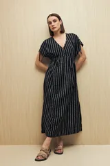 Vestido largo negro con estampado de líneas verticales blancas, escote en V, mangas cortas con lazo ajustable y corte fluido.