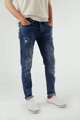 Pantalón de jean azul de corte super skinny con detalles de desgaste.