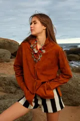 Camisa holgada de cuero suede color marrón, con botones forrados y cuello camisero.