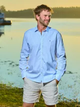 Camisa de hombre de manga larga, corte clásico y cuello italiano con botones. Diseño a cuadros en tonos celeste y blanco. Confeccionada en algodón.