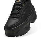 Championes Puma Karmen X-TRA color negro con plataforma gruesa y detalles dorados.