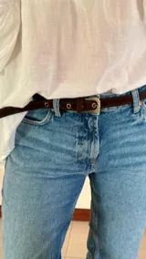 Cinturón delgado con estampado animal print y hebilla metálica dorada.