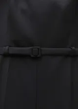 Mono corto negro de tejido mezcla de lana con tirantes anchos, cuello escotado, trabillas y cinturón decorativo. Presenta dos bolsillos laterales, diseño recto y cierre de cremallera invisible en la parte posterior.