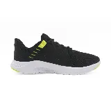 Championes Puma FTR Connect negros con detalles en amarillo flúor y suela blanca.