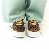 Championes urbanos con plataforma, de animal print color marrón y negro, con cordones dorados y cierre de cremallera lateral con tirador circular.