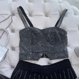 Top tipo corset armado, cubierto en su totalidad de strass plateado, elastizado y con cierre en la espalda.
