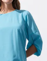 Blusa de gasa color blanco, marca Sioni, de corte recto y mangas 3/4 amplias con abertura y botón.