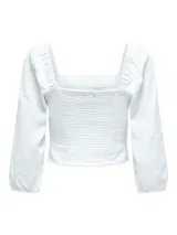 Top blanco de lino con escote cuadrado, mangas largas abullonadas con puños elásticos.
