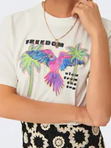 Camiseta color crudo con estampado de palmeras y un loro.