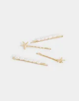 Set de cuatro horquillas doradas para el pelo, dos con apliques de estrellas de mar y dos con apliques de perlas.