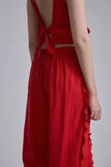 Pantalón rojo de corte palazzo con volados en los laterales.