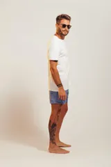 Bañador de hombre color rosa pálido con estampado de golondrinas oscuras. Presenta cintura elástica con cordón ajustable de color crudo y terminales turquesa.