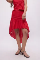 Falda midi color borgoña con tablas hechas con cortes diagonales y frunces.