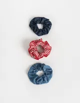 Set de tres scrunchies para el pelo, uno de denim azul oscuro, uno de denim azul claro y uno de tela a cuadros rojos y blancos con volados.