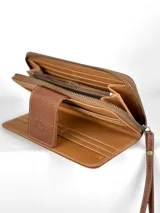 Billetera grande de cuero tricolor: negro, blanco con textura de cocodrilo y marrón claro. Tiene cierre de cremallera, correa de mano y botón de cierre con logo de búho.