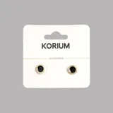 Aros circulares con centro negro y borde dorado con pequeños brillantes.