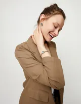 Pulsera elástica de bolas plateadas con un cristal facetado azul.