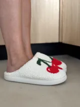 Pantuflas blancas con estampado de cerezas en relieve, ofrecen comodidad y un diseño divertido.