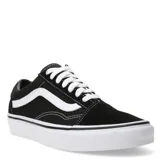 Championes Vans Old Skool negros con la clásica banda lateral blanca, confeccionados en lona y gamuza, con suela de goma blanca tipo waffle.