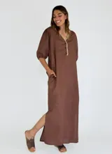 Vestido largo color beige, con escote en V, mangas 3/4 abullonadas y botones frontales.