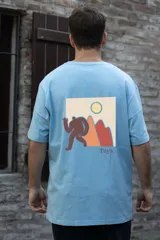 Remera blanca de manga corta con cuello redondo y estampado pequeño en el pecho de una figura humana caminando hacia una montaña.