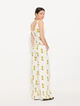 Pantalón palazzo blanco con estampado de limones, confeccionado en ribb con cintura elastizada.