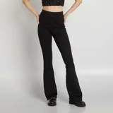 Pantalón flare de tejido elástico color negro, con cintura alta y ajuste ceñido.