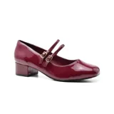 Zapato de charol negro con doble tira sobre el empeine y hebillas plateadas.