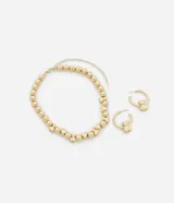 Conjunto de collar corto y caravanas de metal dorado. El collar es de esferas y las caravanas son aros con colgantes de ositos.
