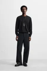 Jersey negro de lana y cashmere, de corte regular, cuello redondo y manga larga.