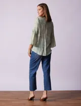 Blusa de gasa estampada color salmón con flores blancas, marca Ruby Rd. Cuello a la base, escote en V y abertura central con botones. Delantera con plisados. Largo de manga ¾ con terminación amplia.