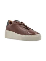 Sneaker Adelaida de cuero graneado color verde oliva, con cordones de algodón y suela elevada color crema.