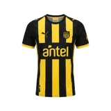 Camiseta de fútbol Puma del Club Atlético Peñarol, modelo Home temporada 2026. Diseño a rayas verticales amarillas y negras, con cuello redondo negro y detalles amarillos en las mangas. Incluye logo Puma, escudo del club y sponsor Antel en el frente.