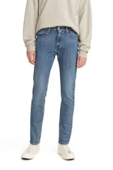 Pantalón jean de corte skinny color azul medio, con tiro medio y confección en tejido rígido.