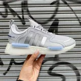 Championes Adidas NMD_V3 color gris con detalles plateados y suela blanca con tecnología Boost.