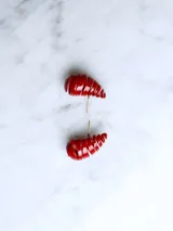 Par de aros con forma de gota, color rojo brillante, con diseño de espiral.