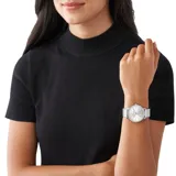 Reloj Michael Kors modelo Pyper con caja plateada de 38 mm, esfera plateada minimalista con indicadores de hora con cristales y correa de malla metálica plateada. Resistente al agua hasta 50 metros.